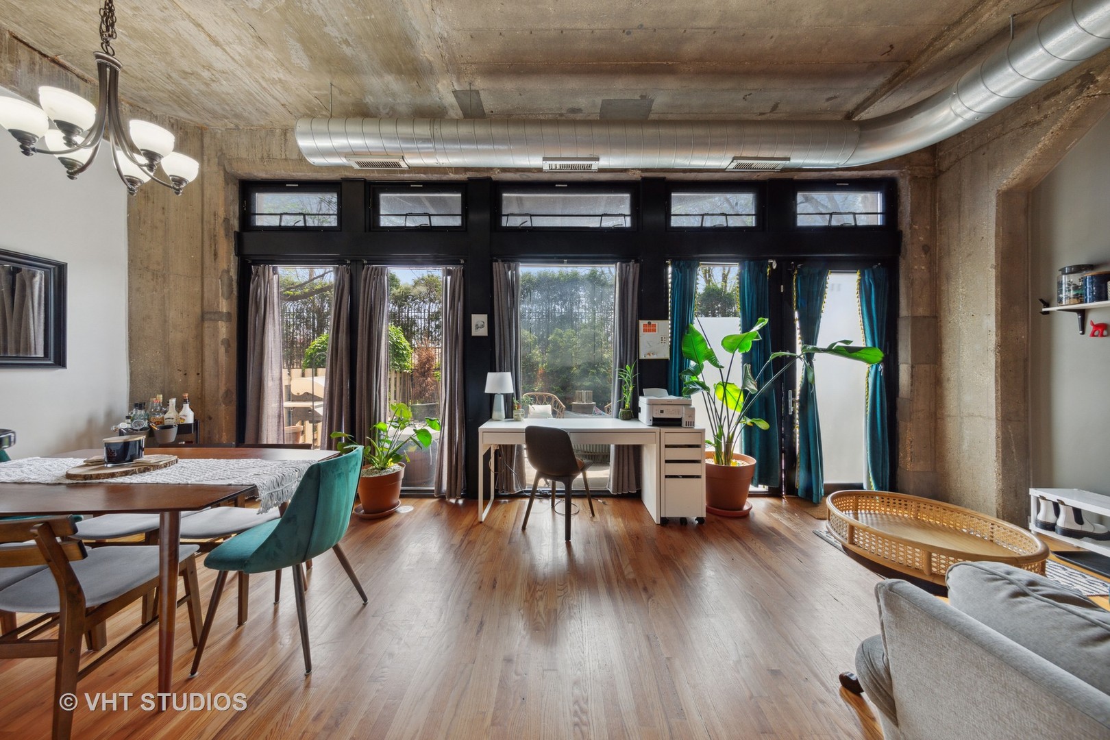 1111 West 15th Street, Unit 115 Chicago, IL 60608 - Photo 5 of 22 a dining room with furniture a chandelier and wooden floor