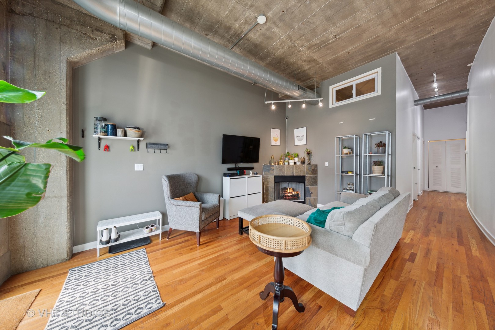 1111 West 15th Street, Unit 115 Chicago, IL 60608 - Photo 6 of 22 a living room with furniture and a flat screen tv