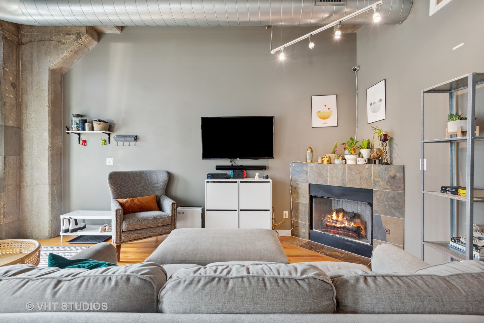 1111 West 15th Street, Unit 115 Chicago, IL 60608 - Photo 7 of 22 a living room with furniture and a fireplace