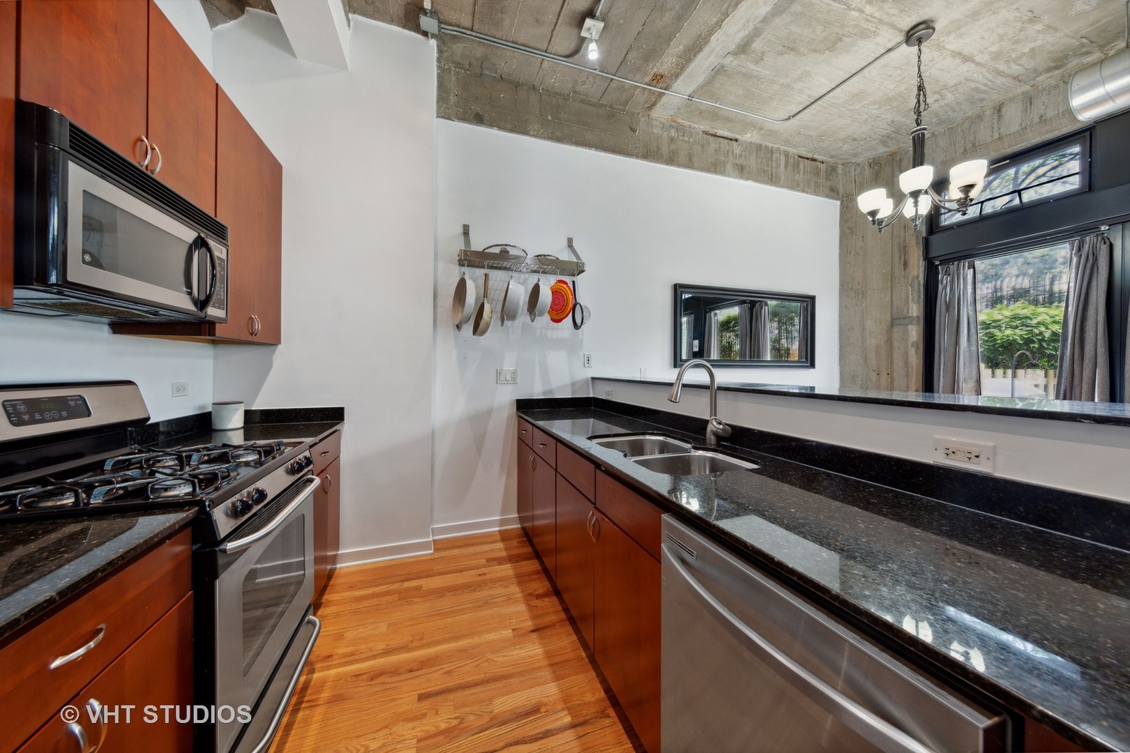 1111 West 15th Street, Unit 115 Chicago, IL 60608 - Photo 10 of 22 a kitchen with stainless steel appliances granite countertop a sink and a stove