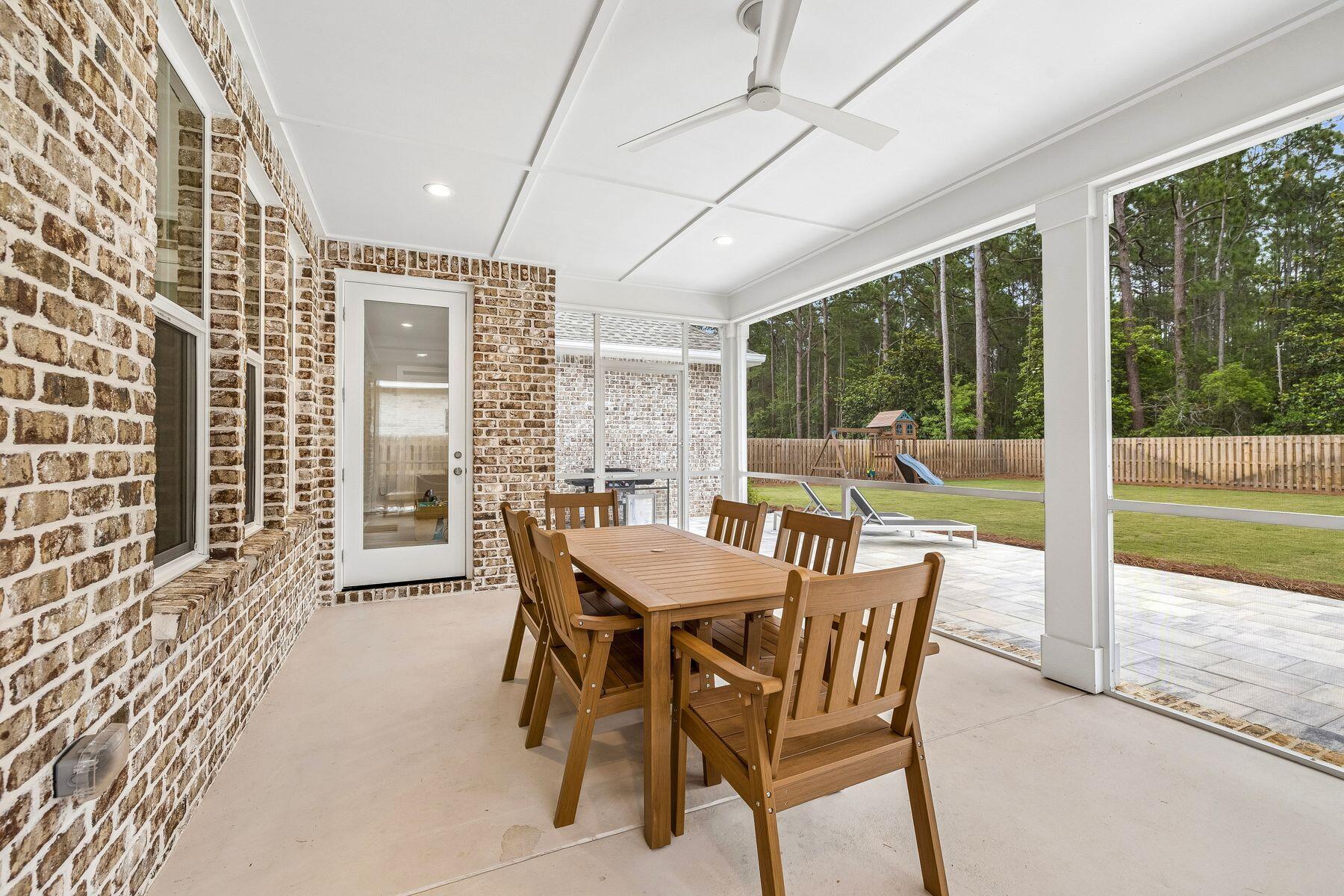 39 West Captain Fritz Way Freeport, FL 32439 - Photo 10 of 33 a view of a dining room with furniture large windows and wooden floor