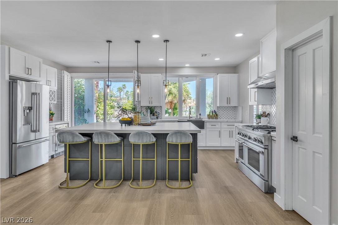 8848 Rainbow Ridge Drive Las Vegas, NV 89117 - Photo 12 of 43 Culinary dreams come alive in this well-appointed kitchen, featuring a spacious island and abundant natural light.