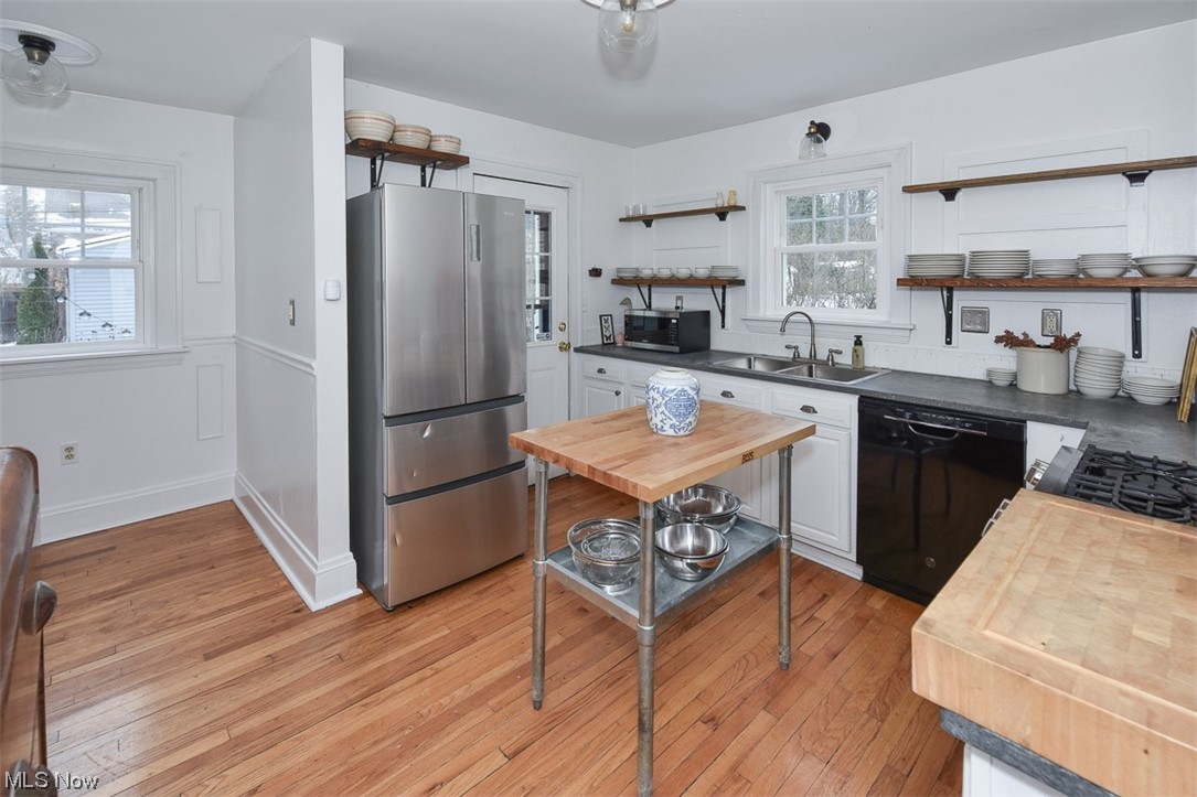 925 Beverly Road Cleveland Heights, OH 44121 - Photo 12 of 25 Kitchen featuring sink, stainless steel appliances, a wealth of natural light, and light hardwood / wood-style flooring
