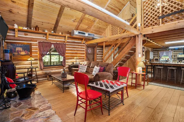 a living room with furniture a fireplace and a table