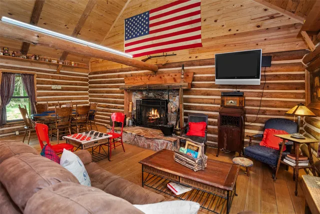 a living room with patio furniture and a fireplace