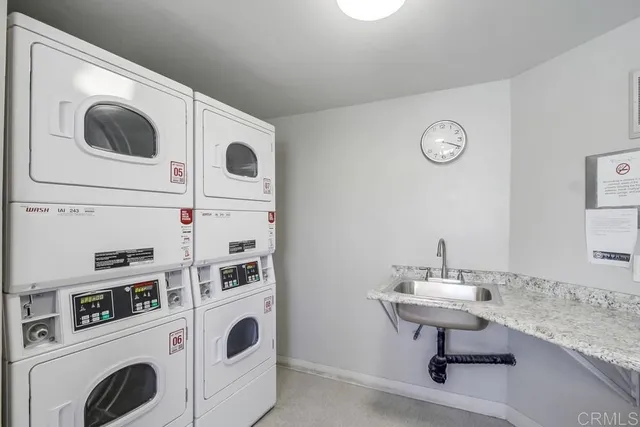 a utility room with dryer washer and a sink