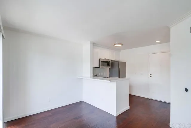 a view of a kitchen with a sink and a refrigerator