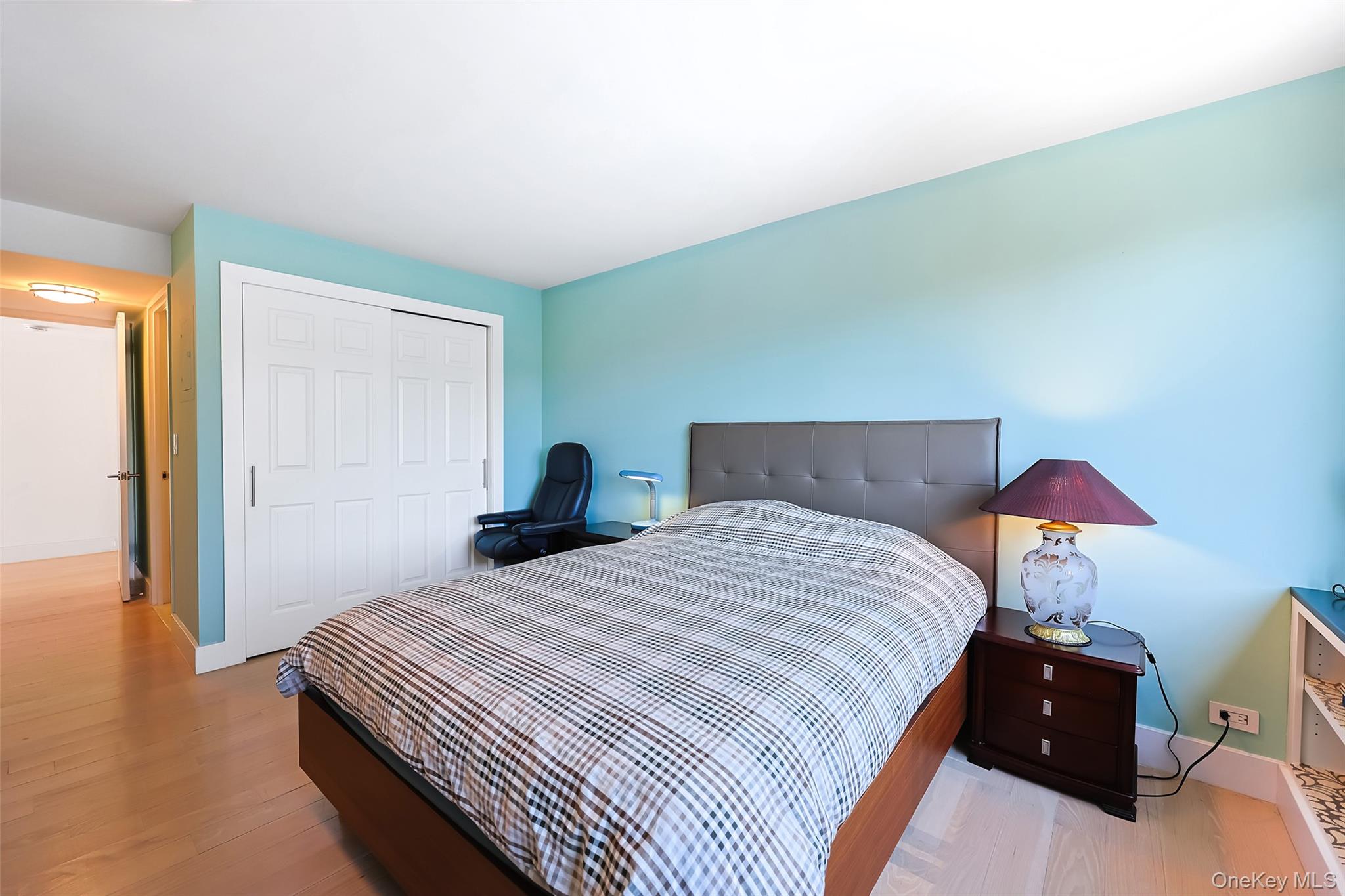 200 Rector Place, Unit 43D Manhattan, NY 10280 - Photo 14 of 27 a bedroom with a bed and a lamp