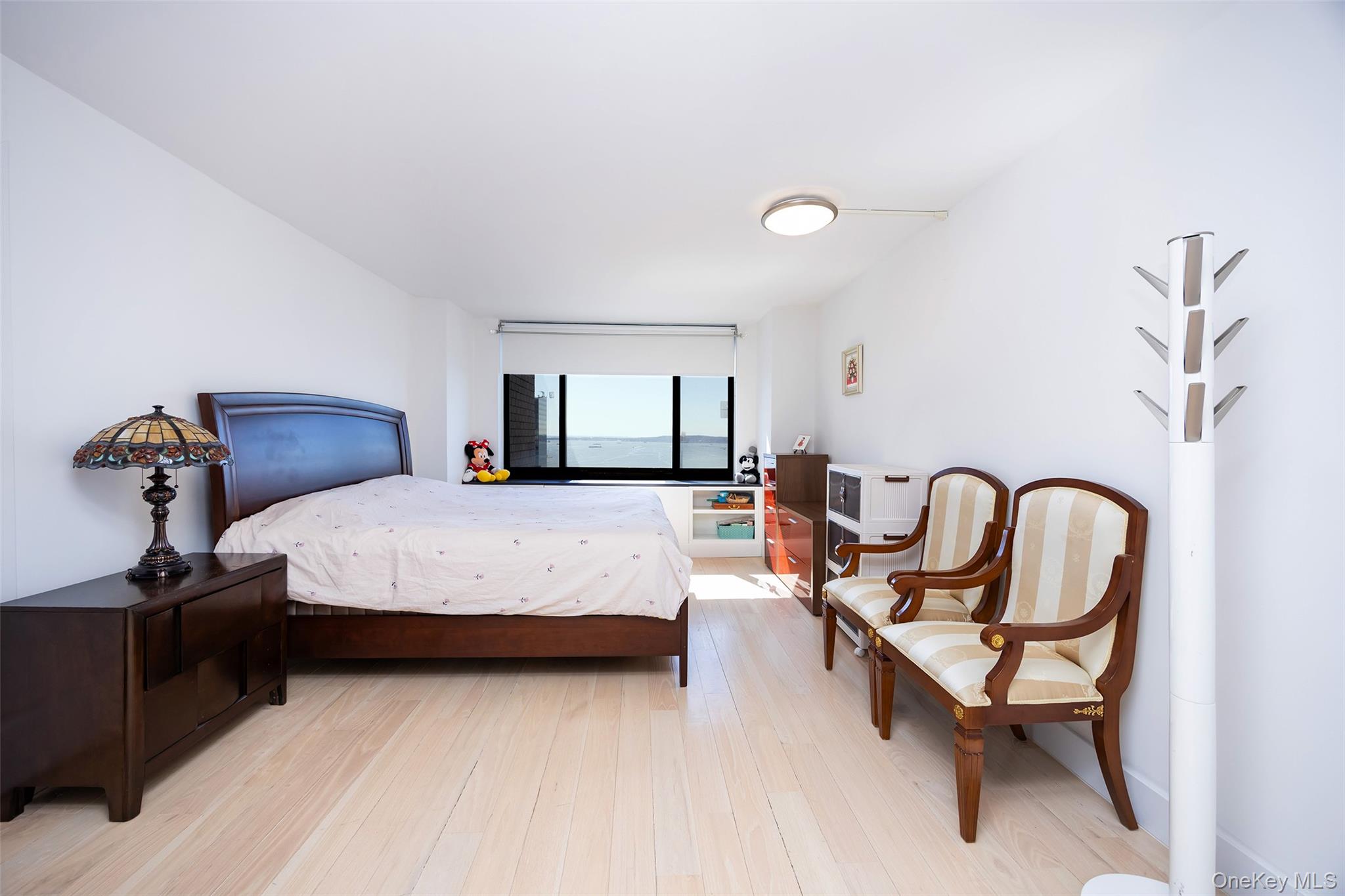 200 Rector Place, Unit 43D Manhattan, NY 10280 - Photo 10 of 27 a bedroom with a bed and wooden floor