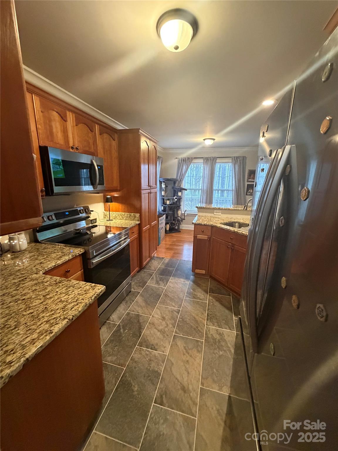 316 Durham Road Stanley, NC 28164 - Photo 5 of 16 a kitchen with stainless steel appliances granite countertop a sink and a stove