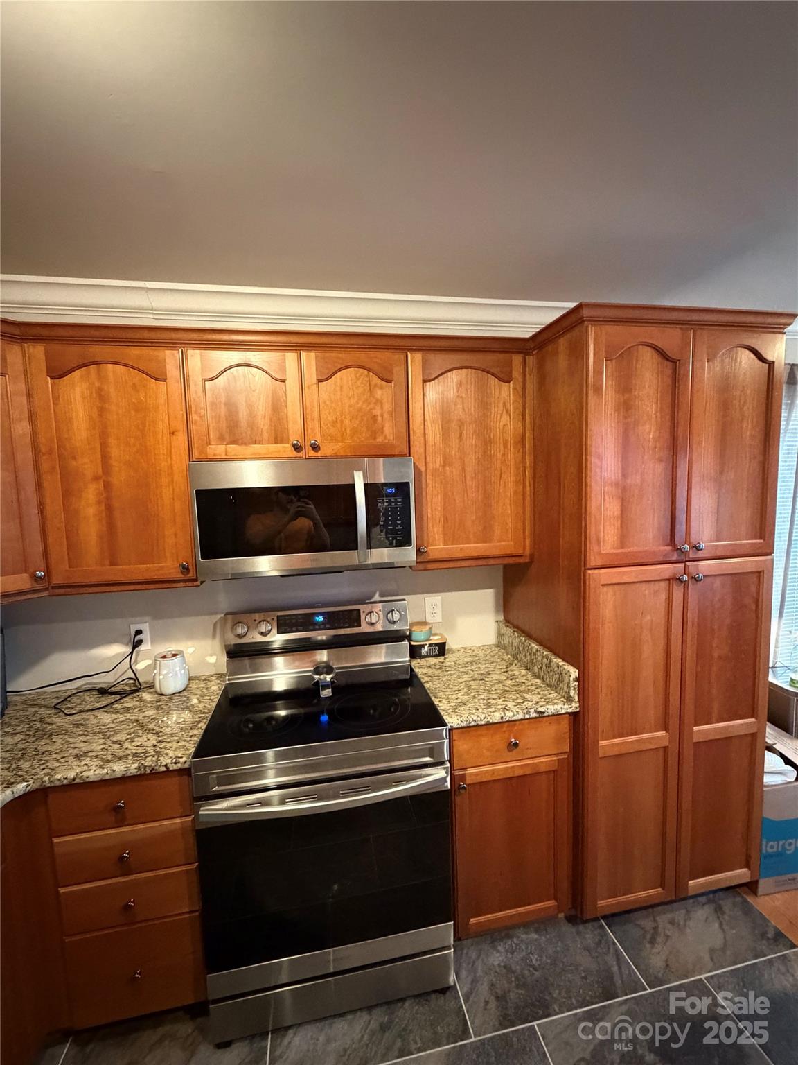 316 Durham Road Stanley, NC 28164 - Photo 6 of 16 a kitchen with granite countertop stainless steel appliances and wooden cabinets