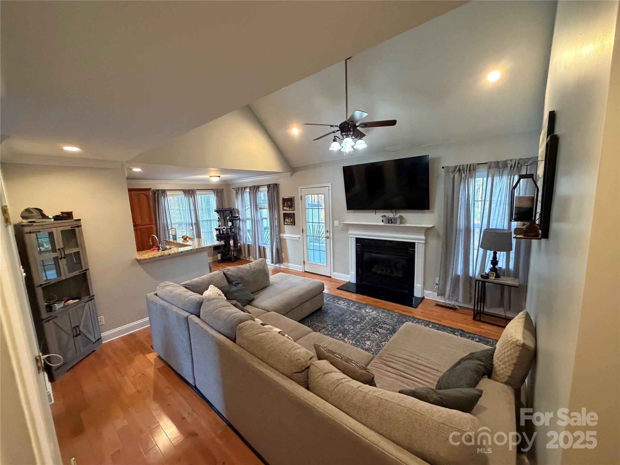 316 Durham Road Stanley, NC 28164 - Photo 10 of 16 a living room with furniture a flat screen tv and a fireplace