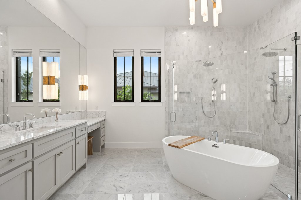 7516 Davenport Divide Road Austin, TX 78738 - Photo 20 of 40 The ensuite features separate vanities, a free-standing soaking tub, and a custom shower with full glass panels and wall of marble.