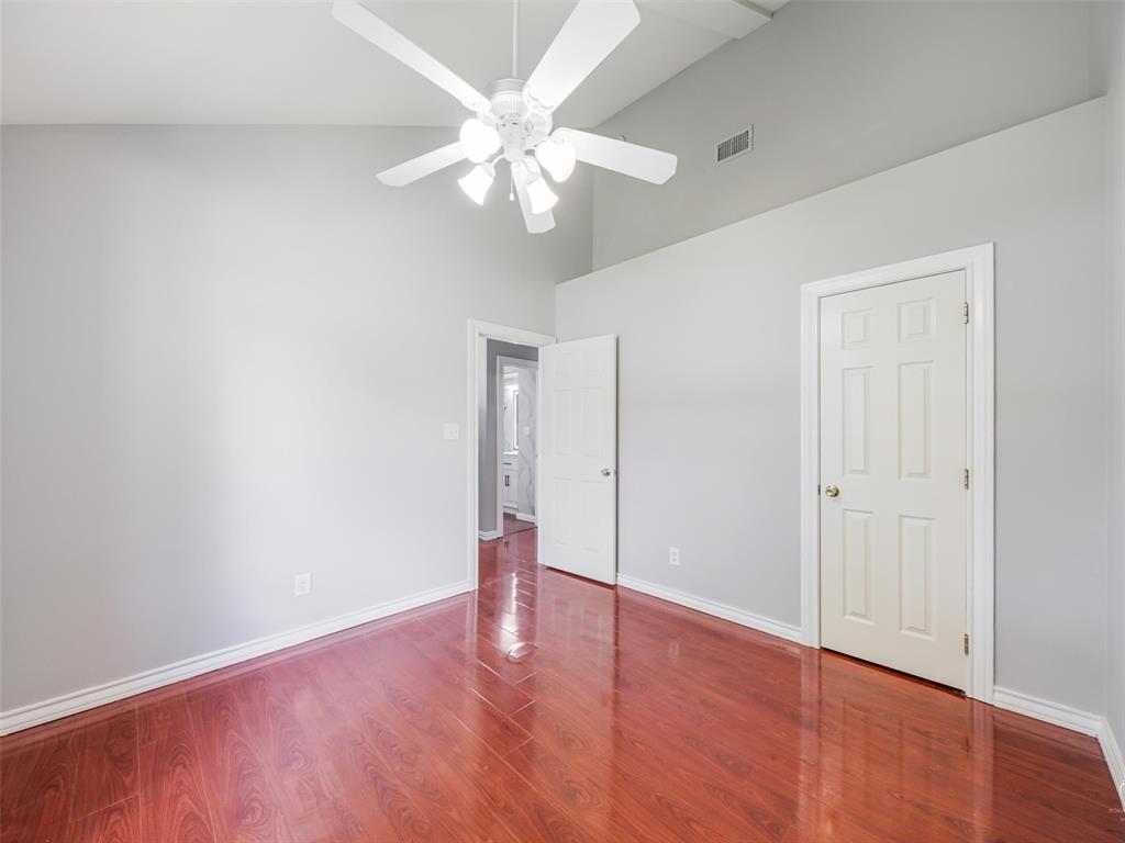1716 East Parker Road Plano, TX 75074 - Photo 14 of 25 Interior room featuring wood-finish flooring, vaulted ceilings, and light gray wall paint