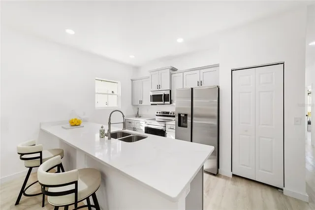 a kitchen with stainless steel appliances a refrigerator and a stove