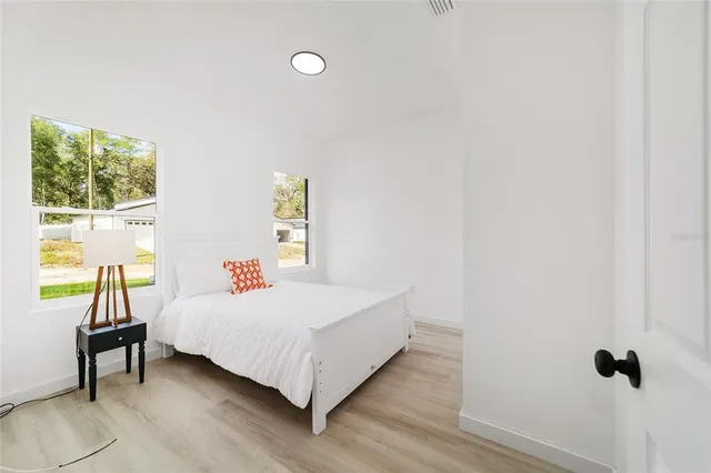 a bedroom with a bed and a window