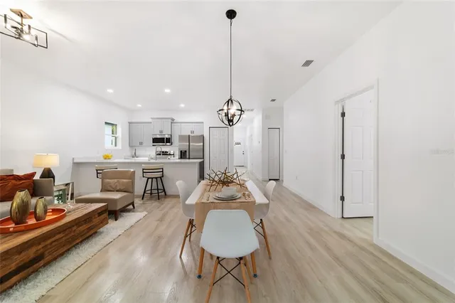 a dining room with furniture and wooden floor