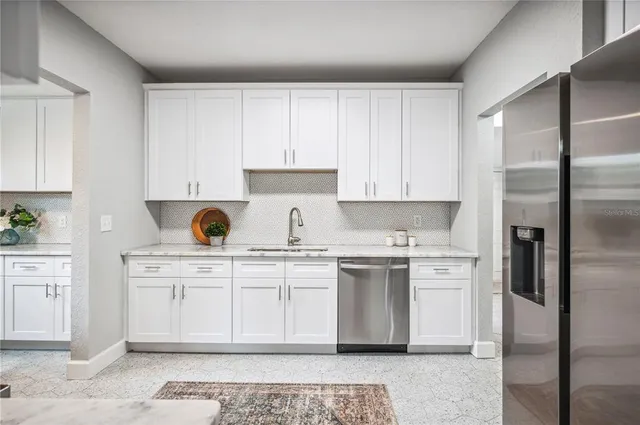 a kitchen with stainless steel appliances granite countertop a stove a refrigerator and a microwave