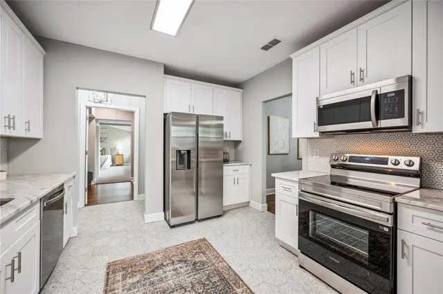 a view of a bathroom with a walk in closet and a bathroom