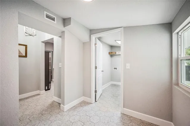 a view of a living room with a large mirror vanity and a glass door shower