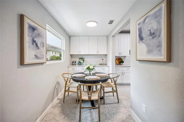 a spacious bedroom with a bed and a chandelier