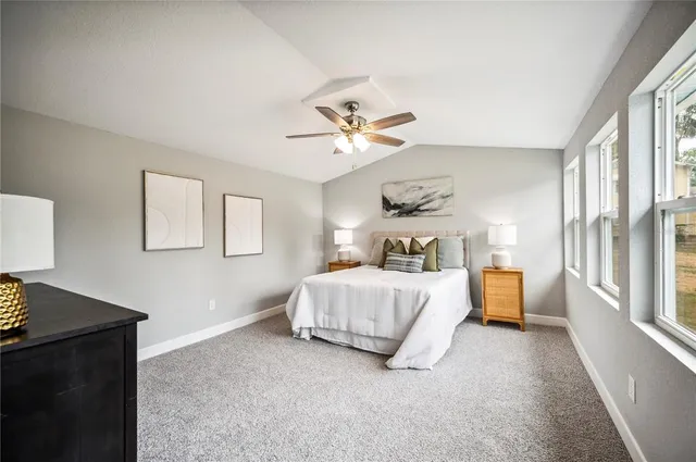 a spacious bathroom with a granite countertop sink a mirror and a shower