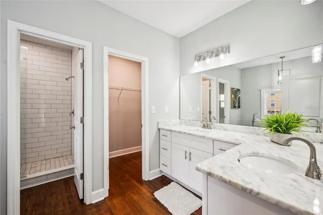 a bathroom with a granite countertop sink a toilet and bathtub