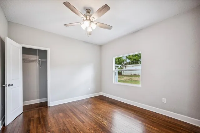 a view of an empty room with wooden floor