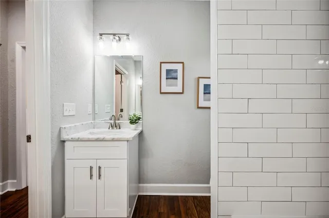 a view of a kitchen with a sink cabinets and wooden floor