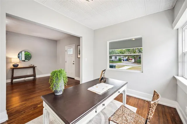 a view of a dining room with furniture and wooden floor