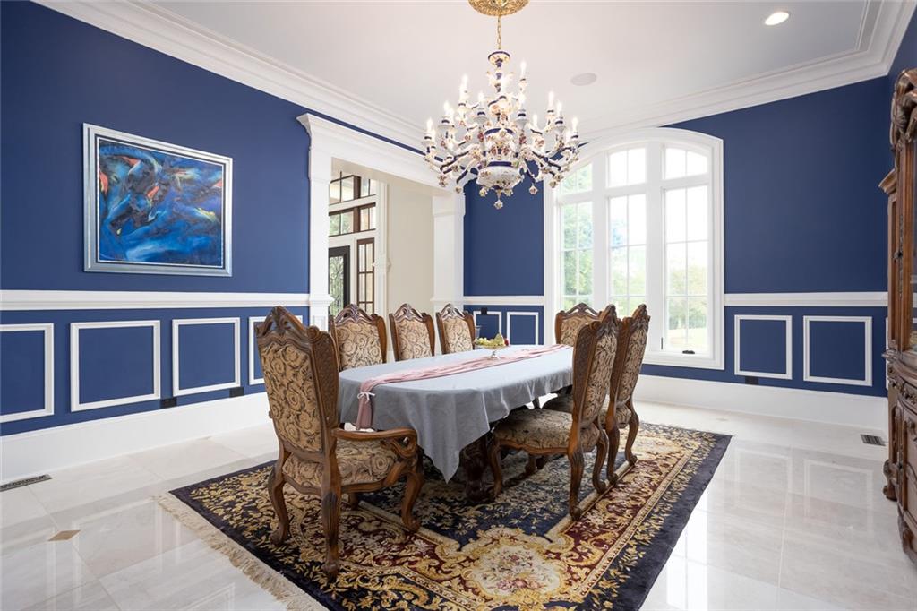3084 George Williams Road Monroe, GA 30656 - Photo 16 of 55 a view of a dining room with furniture a chandelier and wooden floor