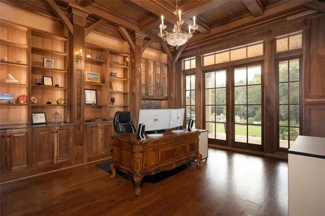 a bathroom with a granite countertop sink a mirror and shower