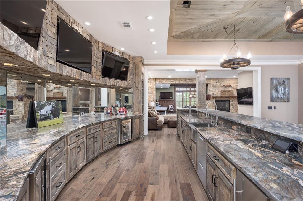 3084 George Williams Road Monroe, GA 30656 - Photo 27 of 55 a large kitchen with stainless steel appliances granite countertop plenty wooden floors