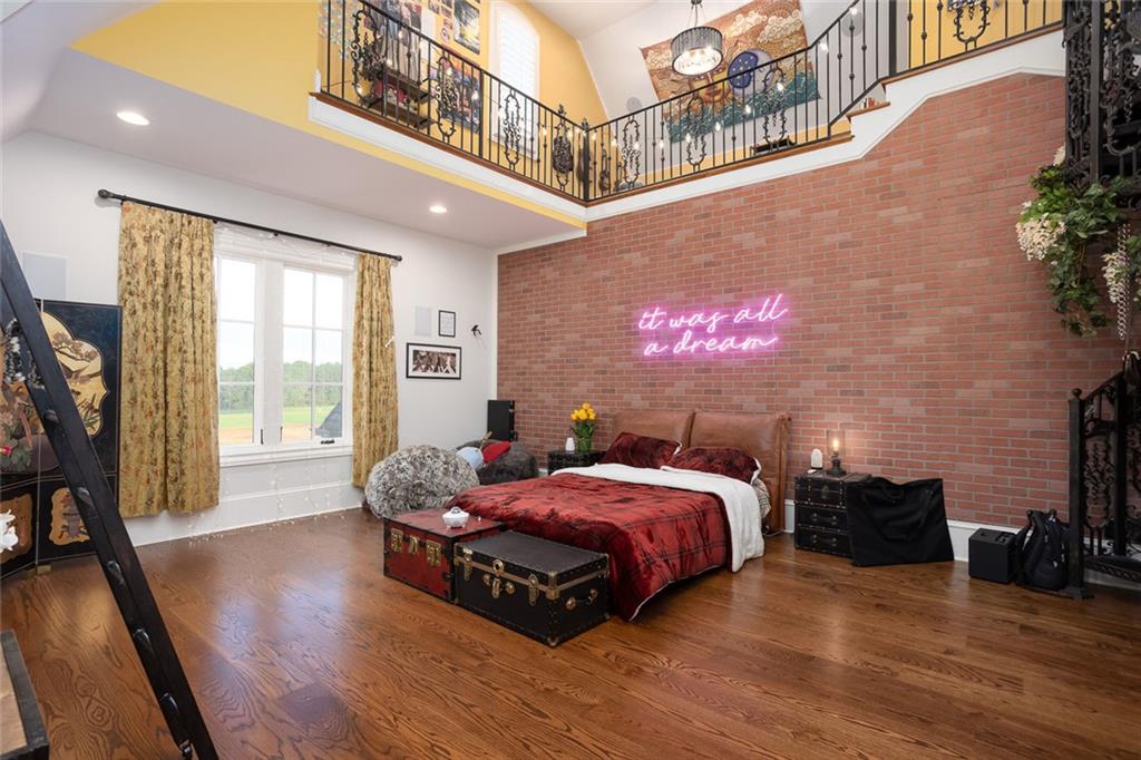 3084 George Williams Road Monroe, GA 30656 - Photo 33 of 55 a spacious bedroom with a bed and wooden floor