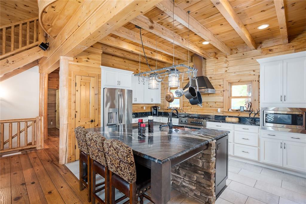 3084 George Williams Road Monroe, GA 30656 - Photo 43 of 55 a dining hall with stainless steel appliances granite countertop a stove a sink dishwasher and cabinets with wooden floor
