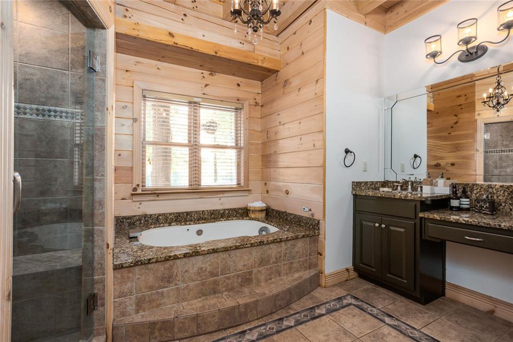 3084 George Williams Road Monroe, GA 30656 - Photo 46 of 55 a bathroom with a granite countertop bathtub sink vanity and mirror