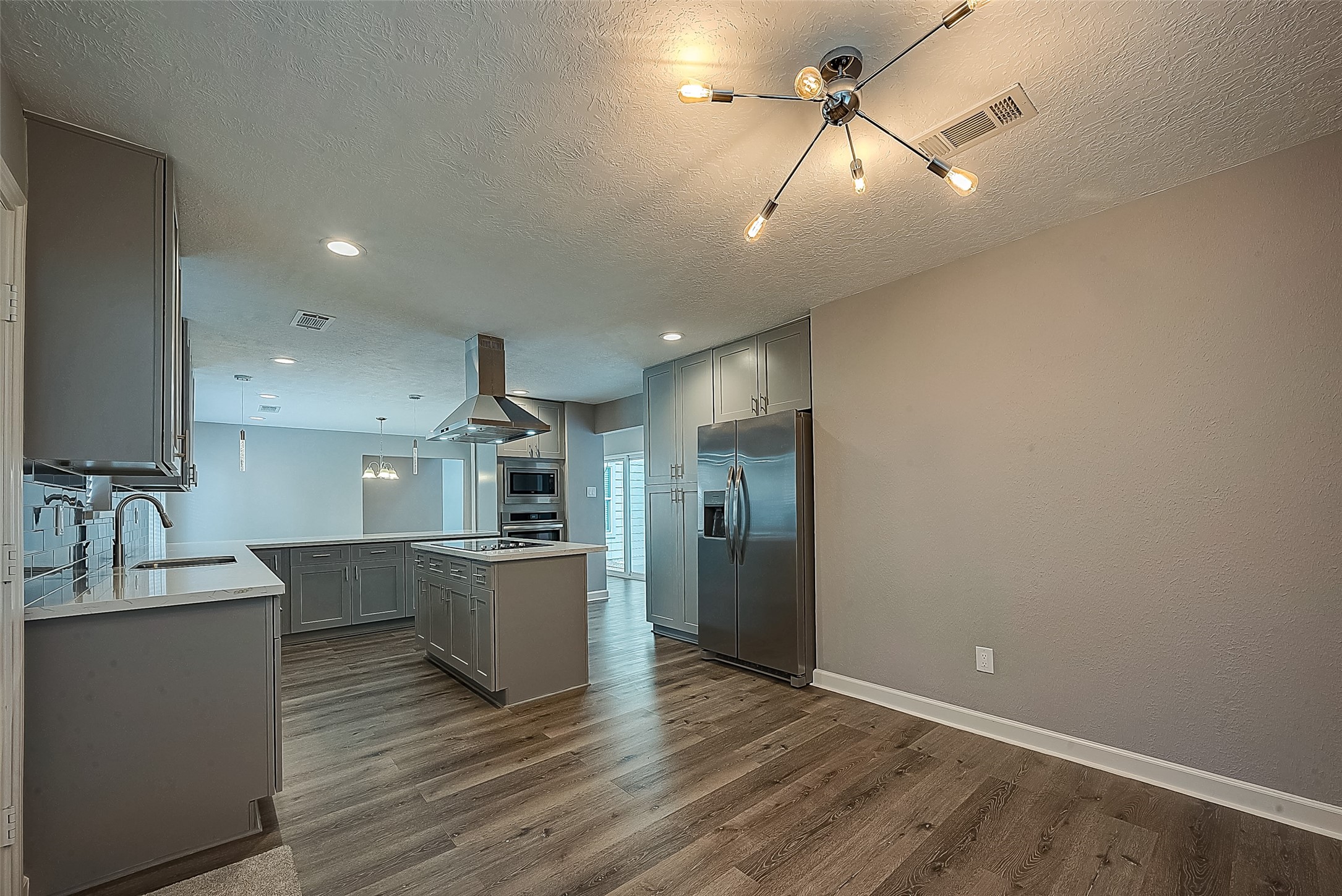 1623 Cherry Ridge Drive Houston, TX 77077 - Photo 11 of 44 a kitchen with kitchen island a counter top space appliances and cabinets