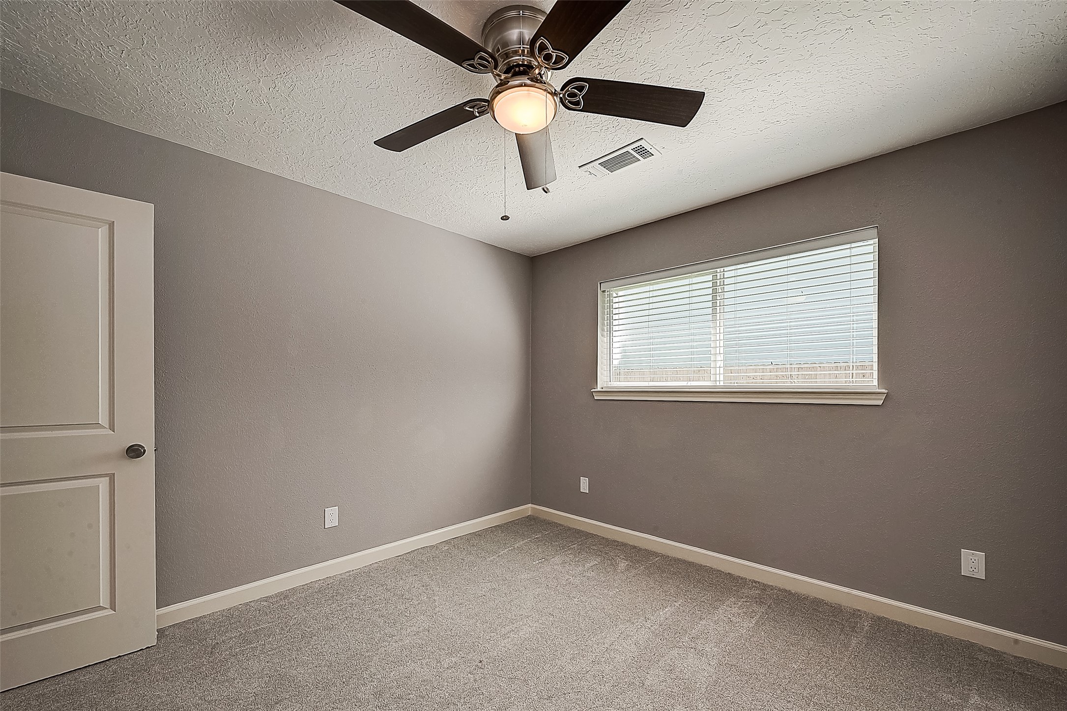 1623 Cherry Ridge Drive Houston, TX 77077 - Photo 12 of 44 an empty room with a window and a fan