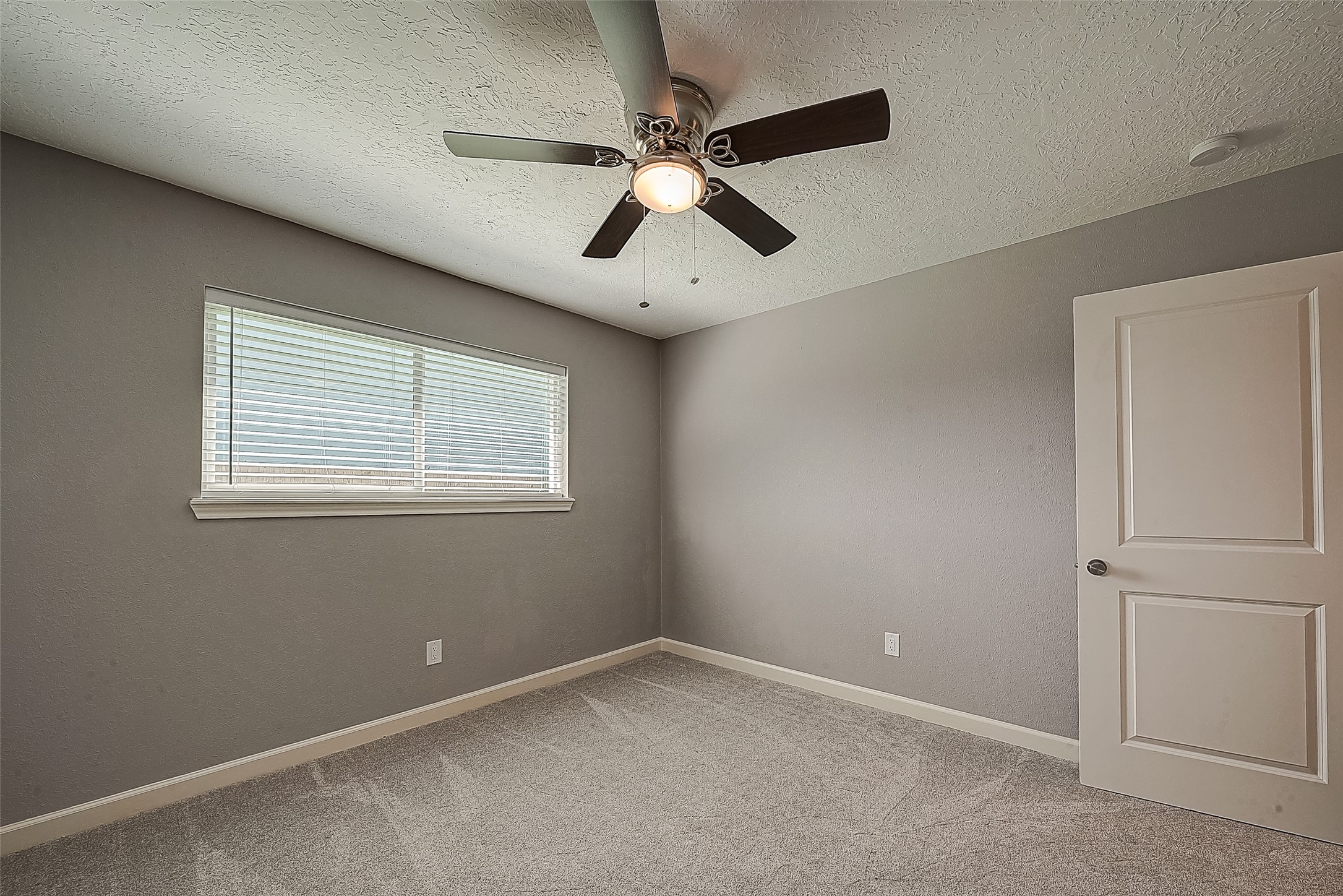 1623 Cherry Ridge Drive Houston, TX 77077 - Photo 17 of 44 an empty room with a window and a fan