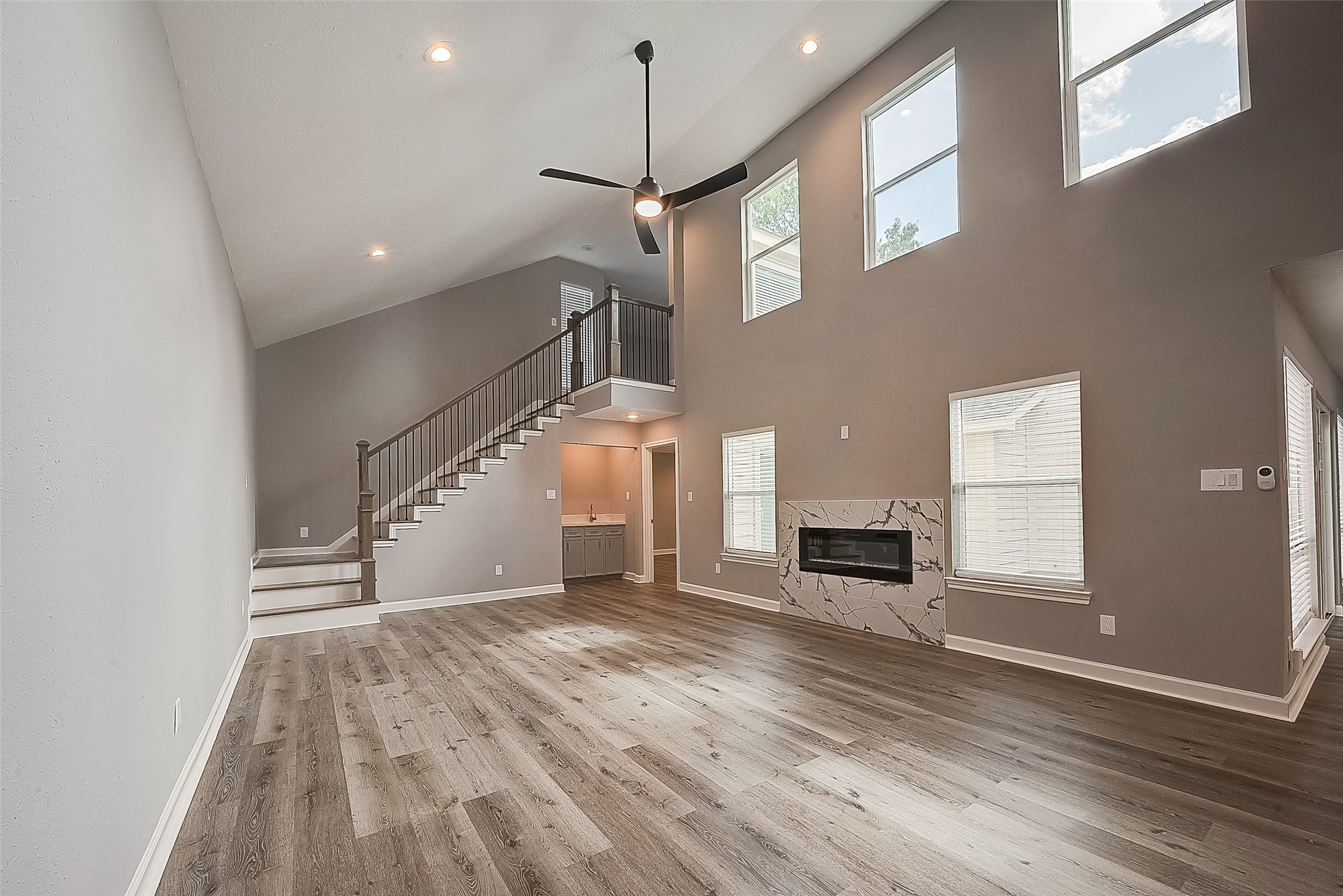 1623 Cherry Ridge Drive Houston, TX 77077 - Photo 21 of 44 a view of a livingroom with wooden floor and a ceiling fan