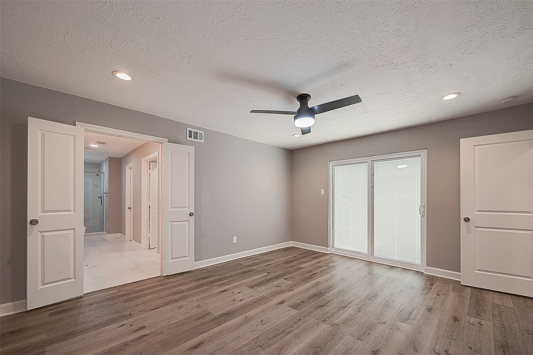 1623 Cherry Ridge Drive Houston, TX 77077 - Photo 26 of 44 a view of empty room with wooden floor and fan