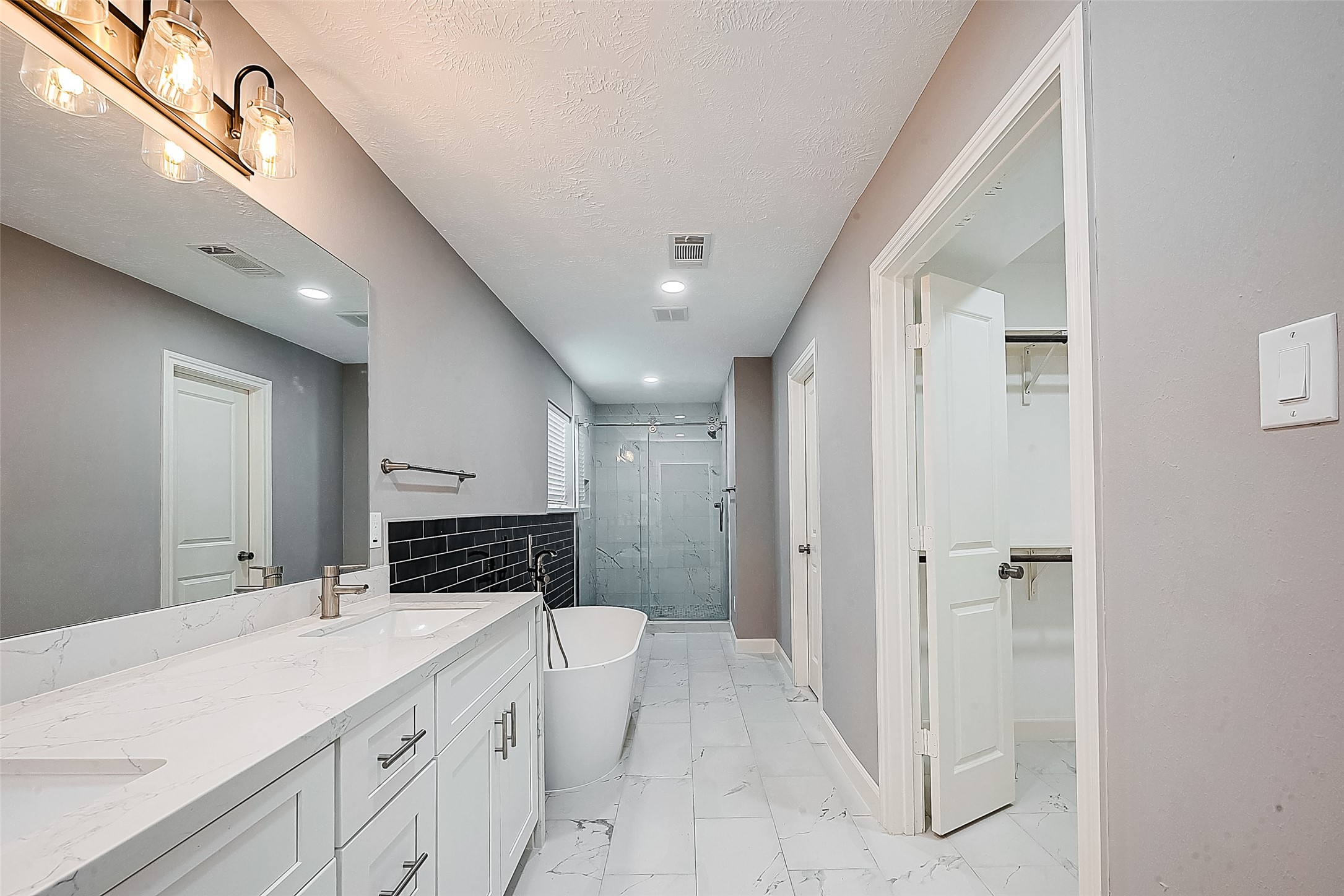 1623 Cherry Ridge Drive Houston, TX 77077 - Photo 27 of 44 a bathroom with a granite countertop sink a mirror and a shower