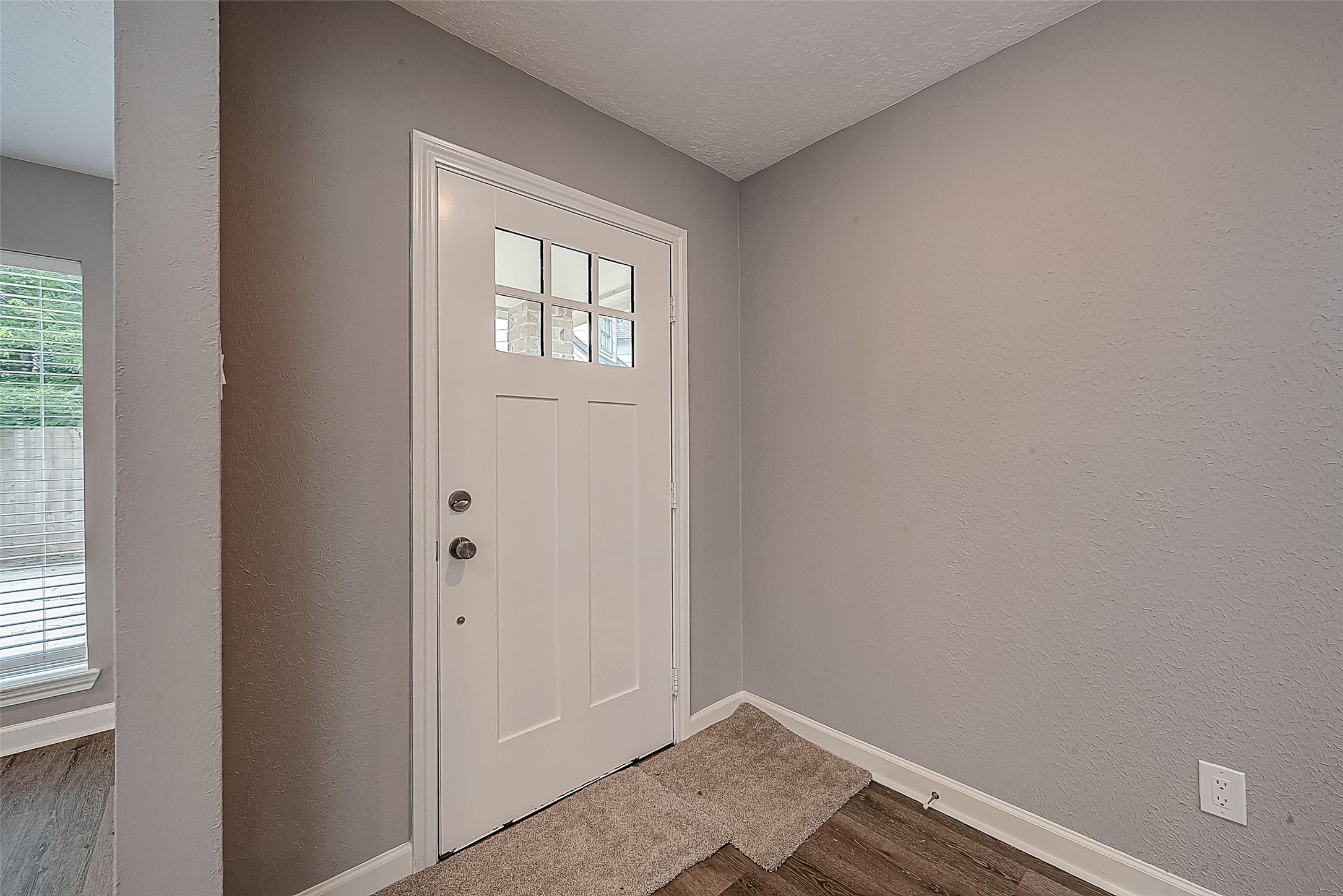 1623 Cherry Ridge Drive Houston, TX 77077 - Photo 3 of 44 a view of an empty room with wooden floor and a window