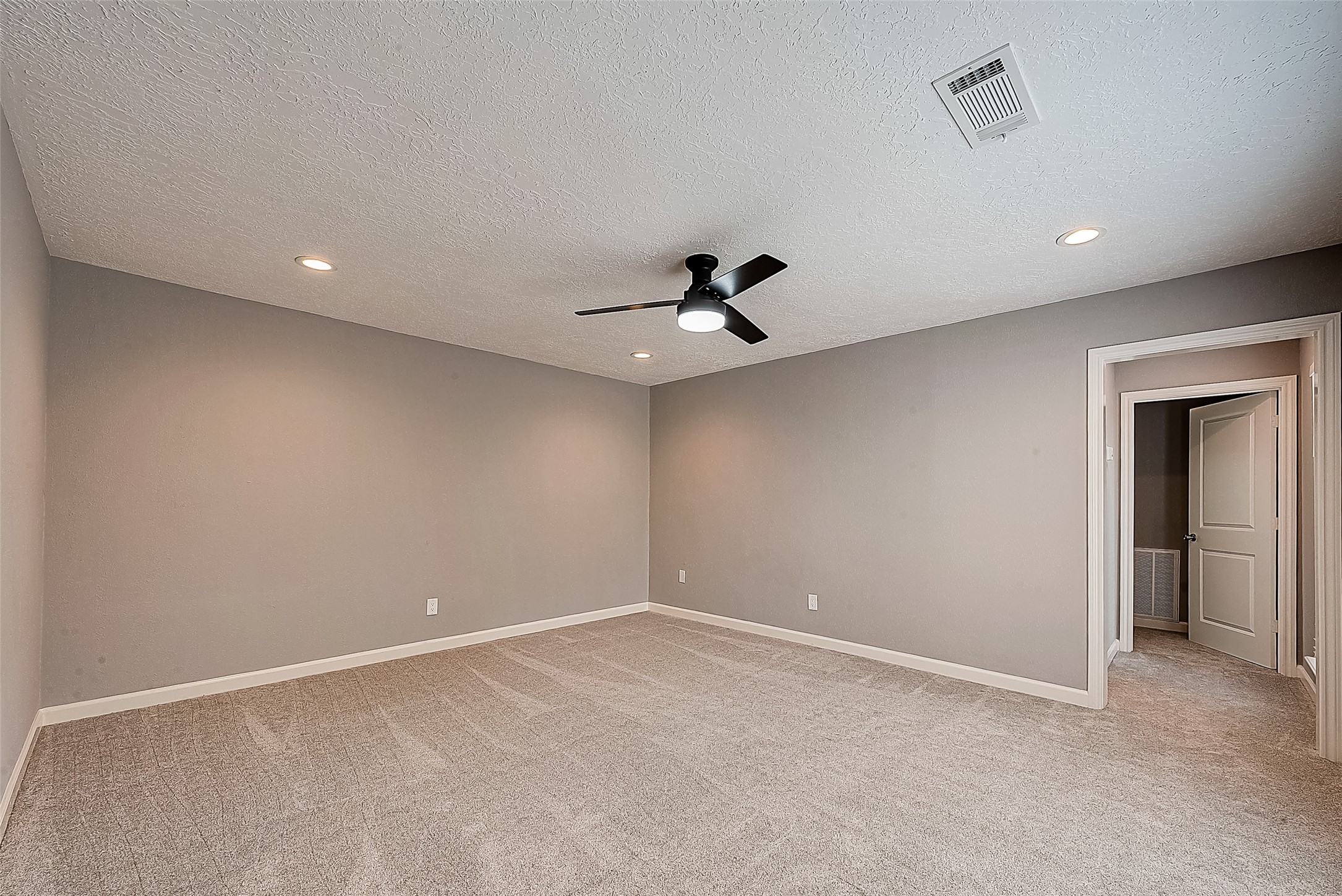 1623 Cherry Ridge Drive Houston, TX 77077 - Photo 33 of 44 an empty room with a ceiling fan and a window