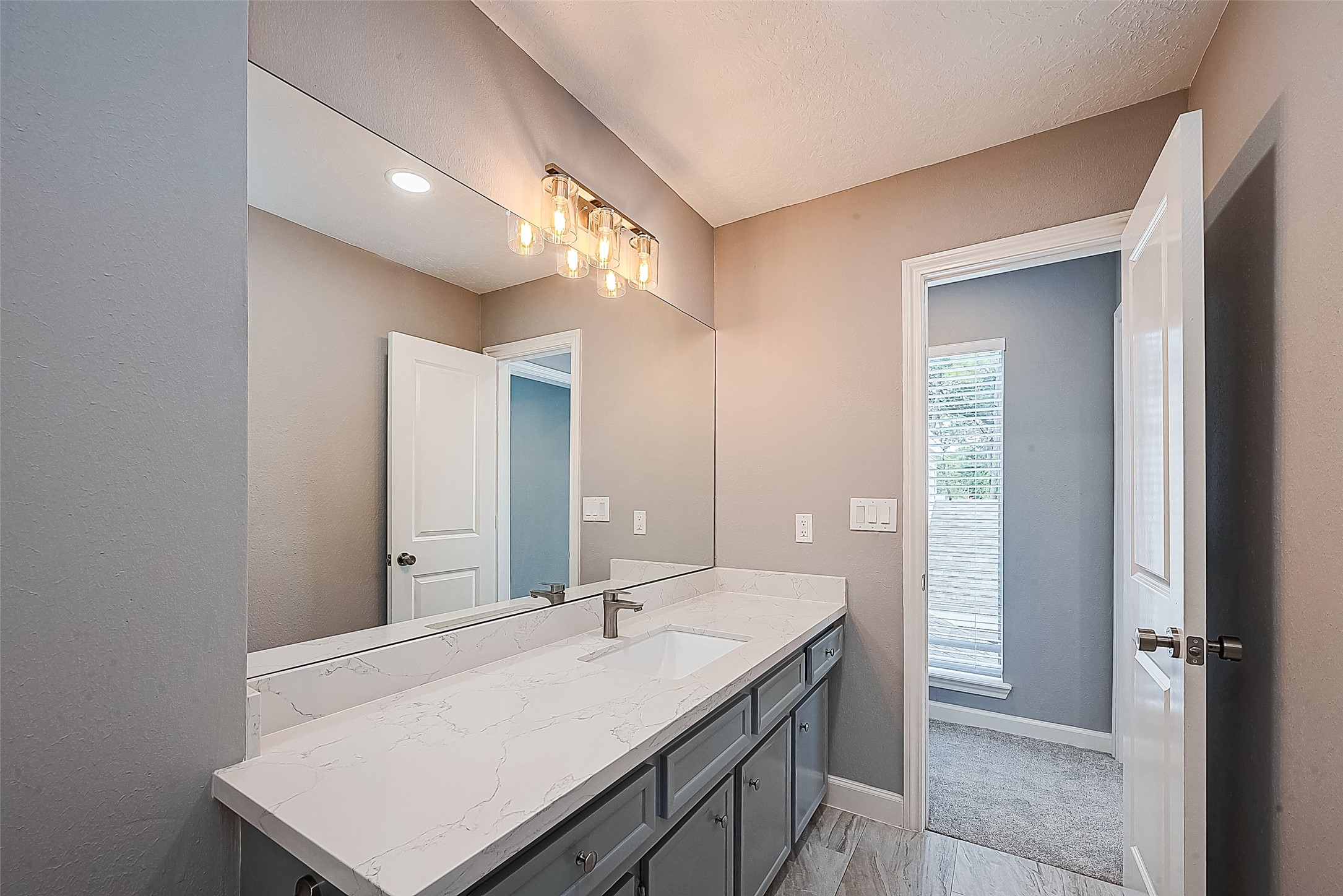 1623 Cherry Ridge Drive Houston, TX 77077 - Photo 37 of 44 a bathroom with a sink a mirror and a vanity
