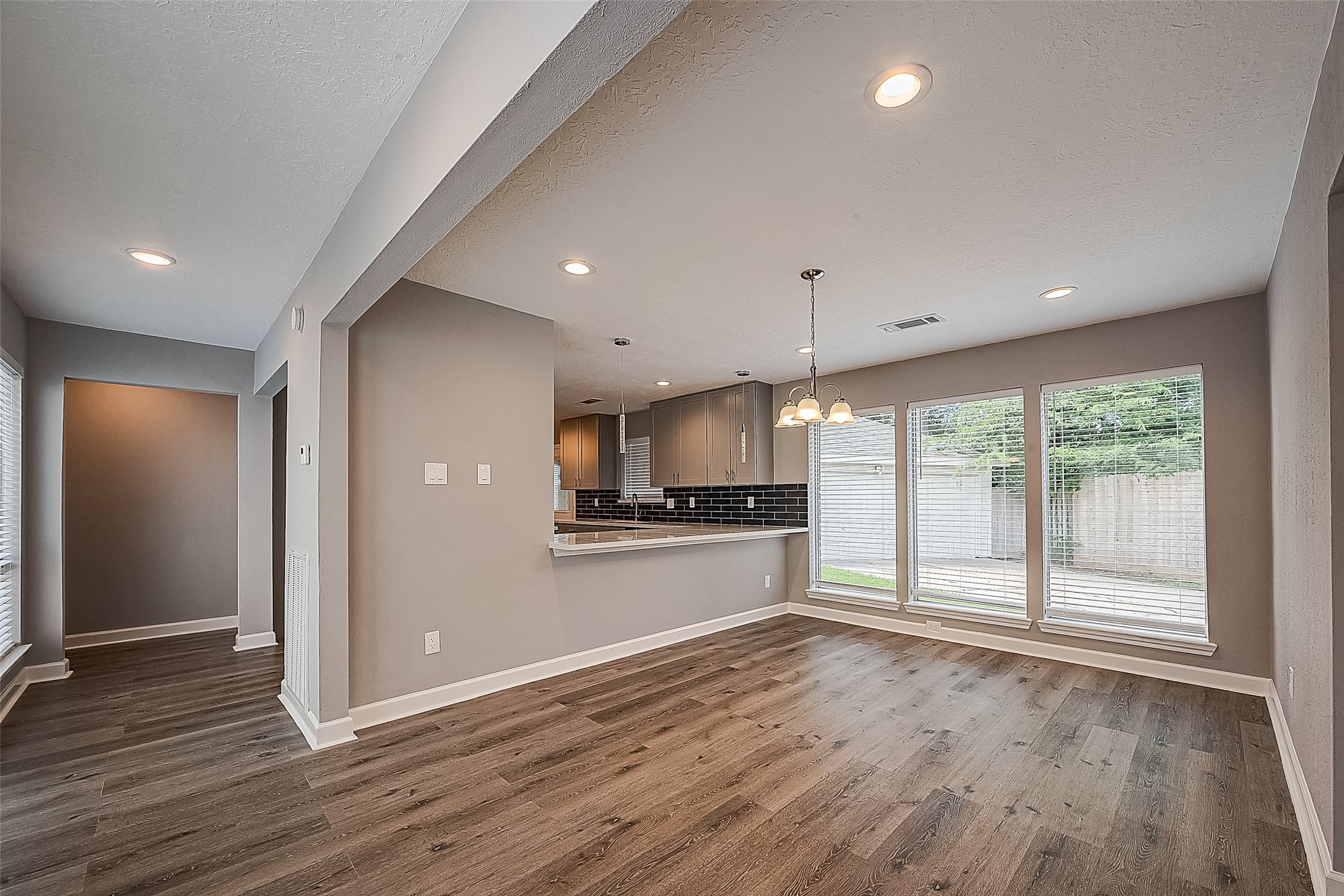 1623 Cherry Ridge Drive Houston, TX 77077 - Photo 4 of 44 an empty room with wooden floor and windows