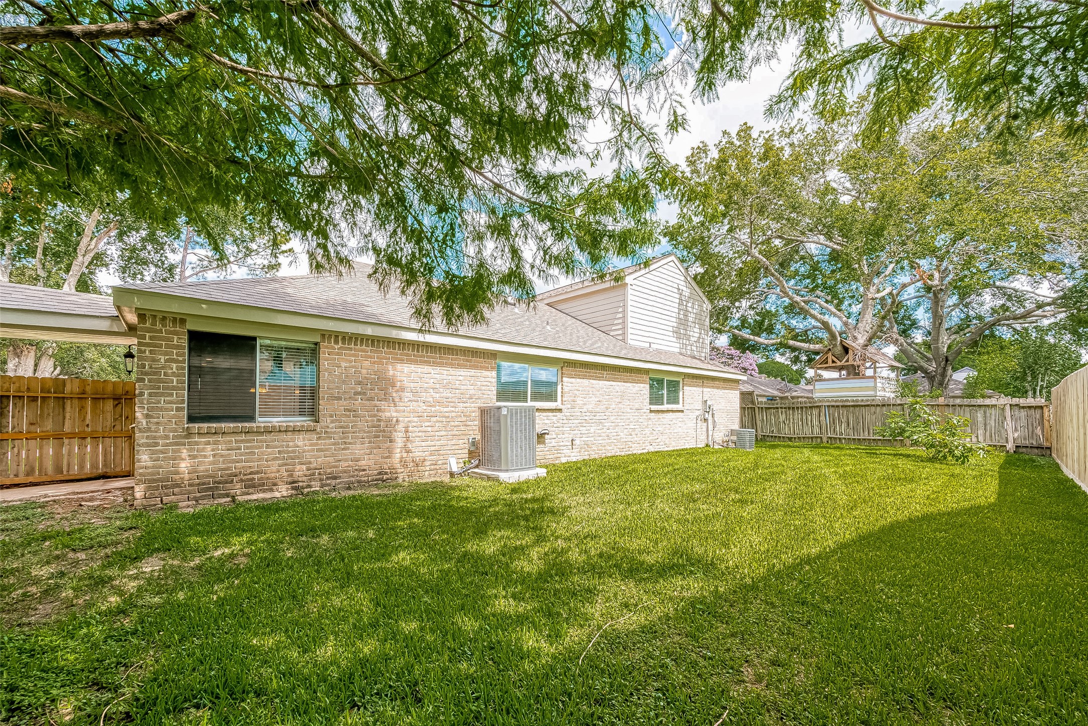 1623 Cherry Ridge Drive Houston, TX 77077 - Photo 43 of 44 a front view of house with yard and trees in the background