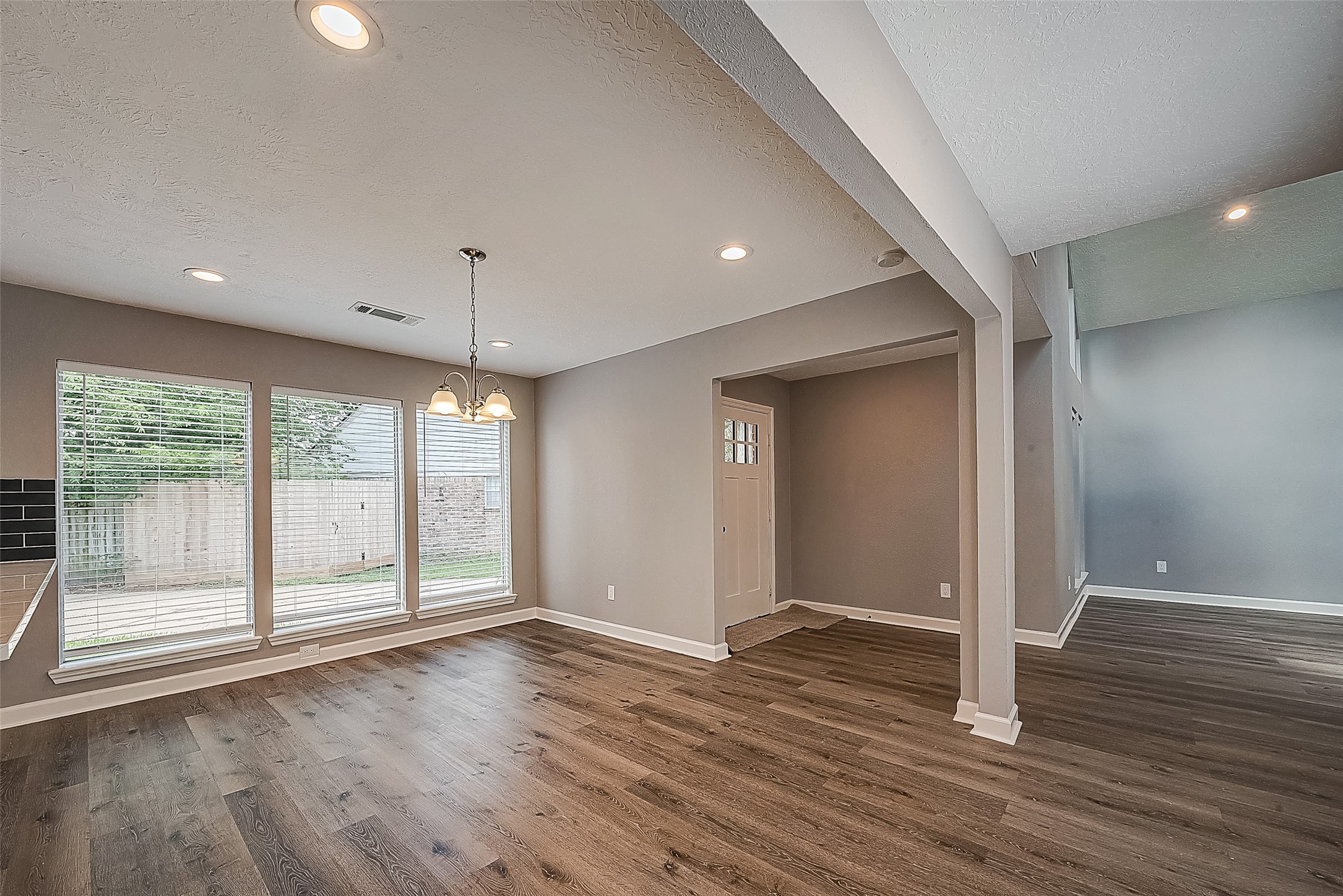 1623 Cherry Ridge Drive Houston, TX 77077 - Photo 5 of 44 a view of an empty room with wooden floor and a window