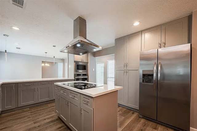 a kitchen with stainless steel appliances granite countertop a refrigerator a sink and a stove