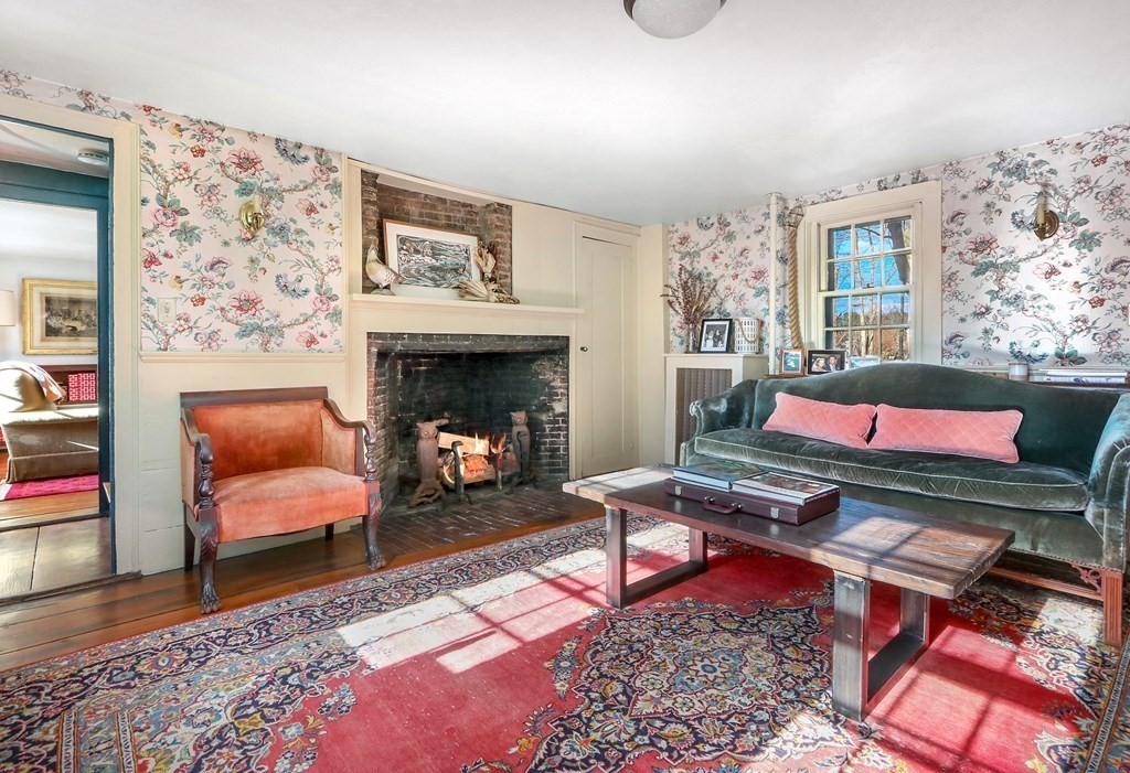 150 Concord Road Sudbury, MA 01776 - Photo 12 of 34 a living room with furniture a rug and a fireplace